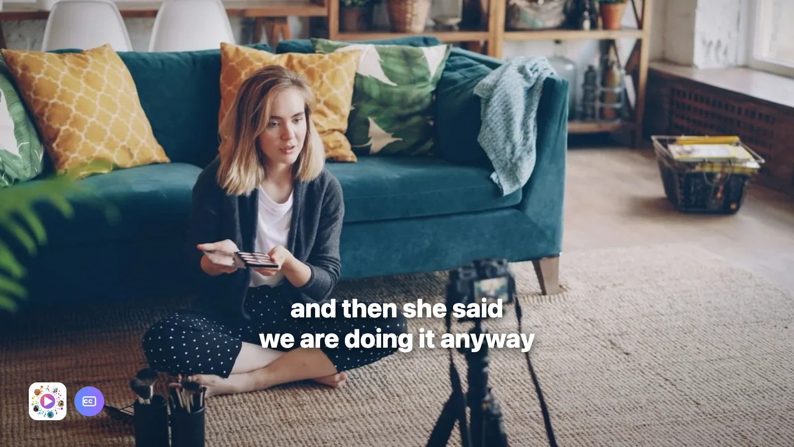 Someone talking to a camera on a tripod in a living room, with a caption burnt across the bottom of the picture.