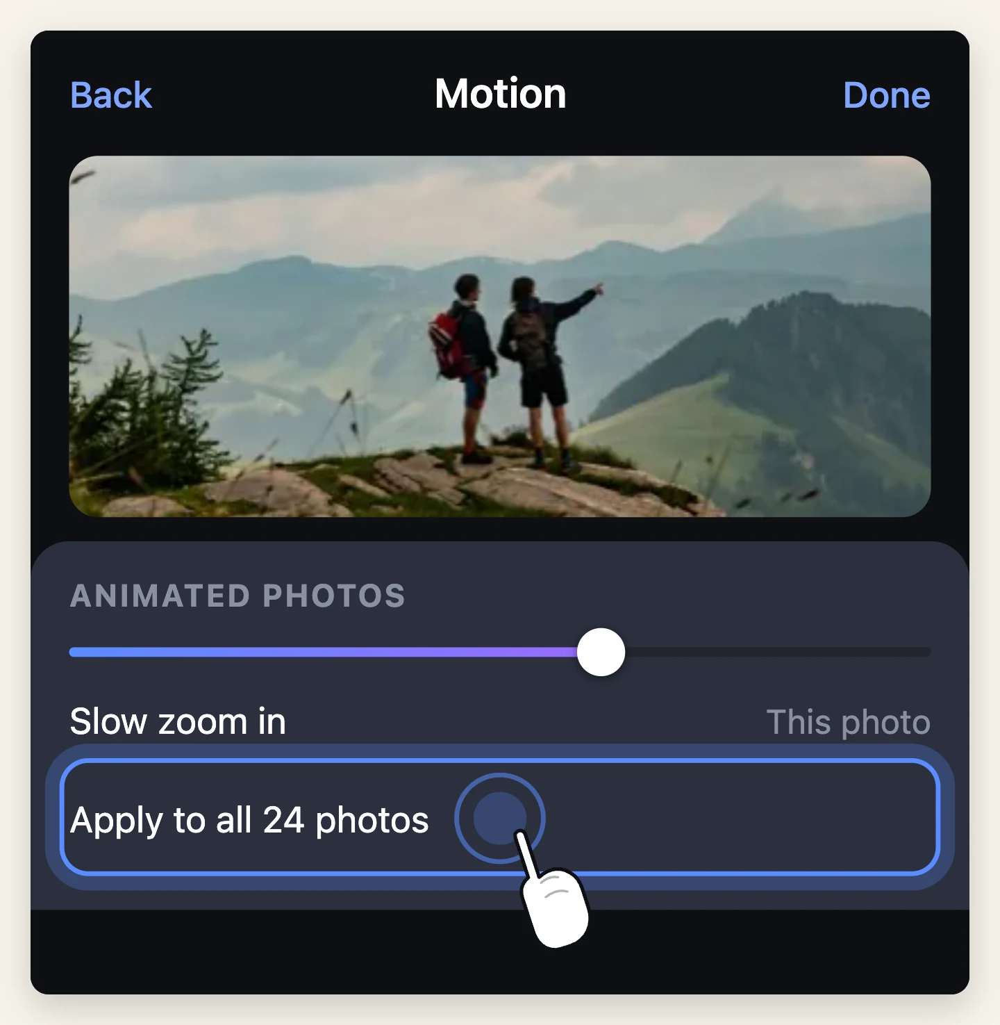 The motion panel with a slow zoom set on one photo and an Apply to all photos row highlighted, with a finger on it.